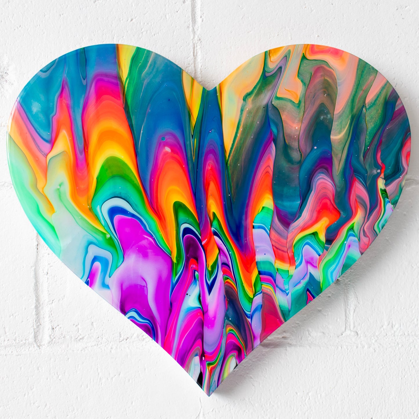 Crazy Love, (20.5” X18”) by Callen Schaub, features vibrant multicolored zigzags across a resined, heart-shaped canvas. This abstract abstract work is the 15th painting in the artist's After Life Collection.